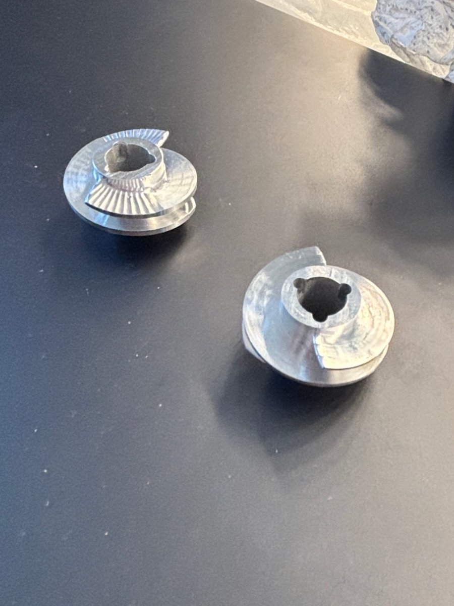 The two finished aluminum inducers after the final cut, sitting on a desk