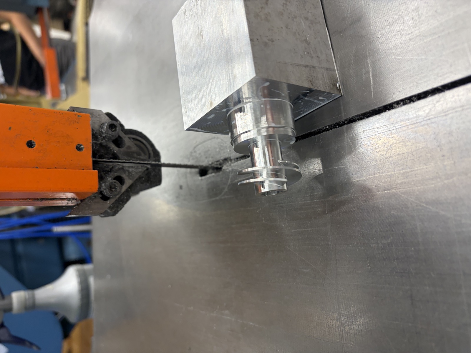 Bandsaw parting the finished inducer off its billet stock