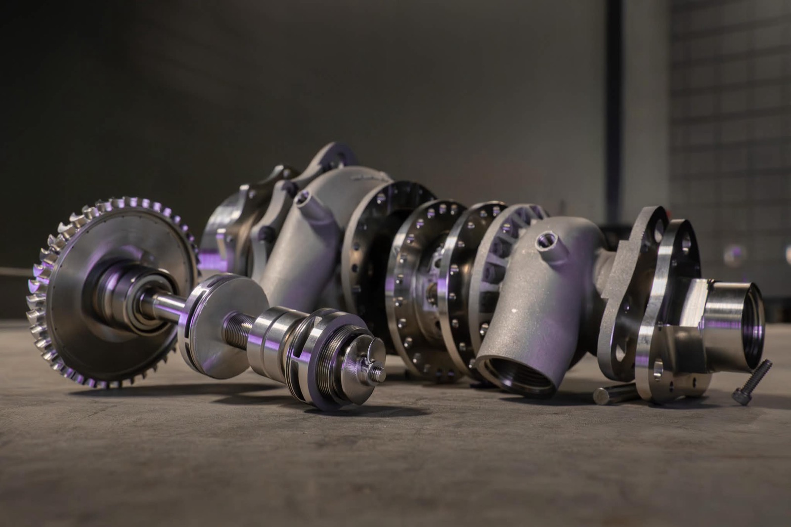 The assembled V1 turbopump hardware laid out under studio lighting
